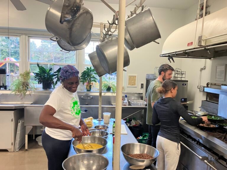 Donna stirring in the church kitchen with volunteers