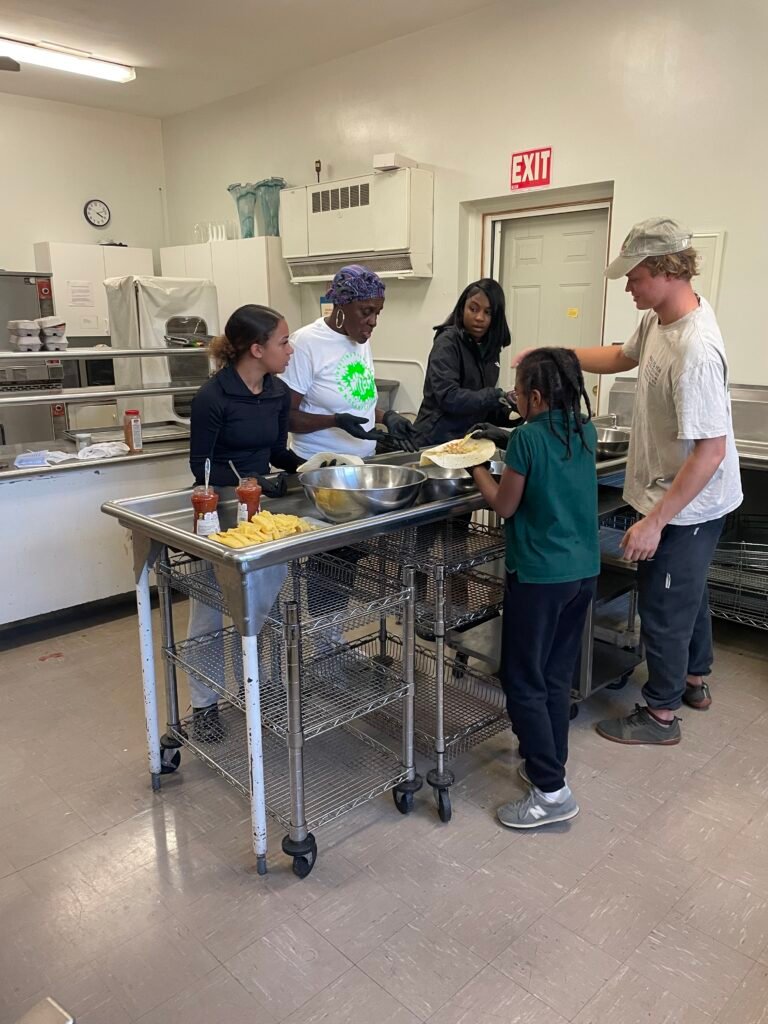 Young cooks making breakfast burritos in the church kitchen
