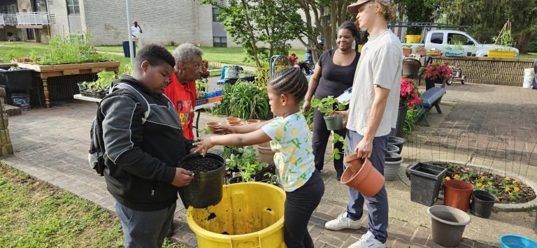 Young volunteers filling pots for the plant distribution