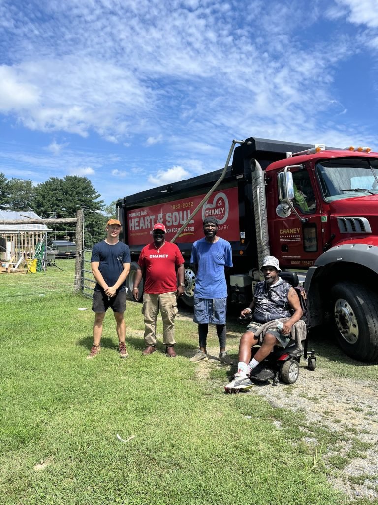 Matthew, Kareem and Randy with a Chaney Enterprises driver delivering fill to level the greenhouse floor