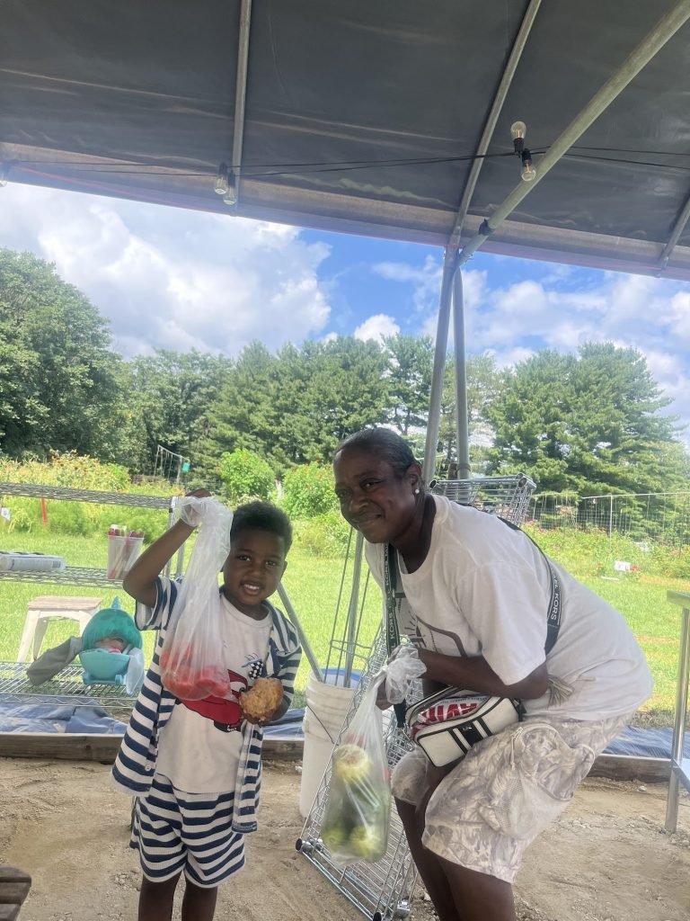 Neighbor Dominique and her grandson, who came to the garden every day to pick vegetables