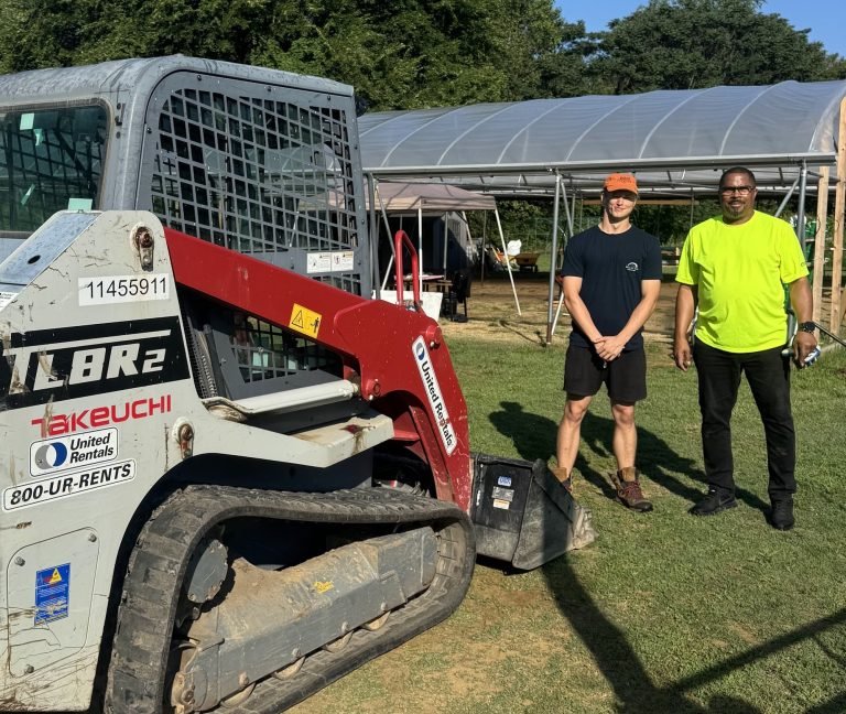Robert Hector Jr. of United Rentals Annapolis with Matthew, delivering a skid steer for the greenhouse build