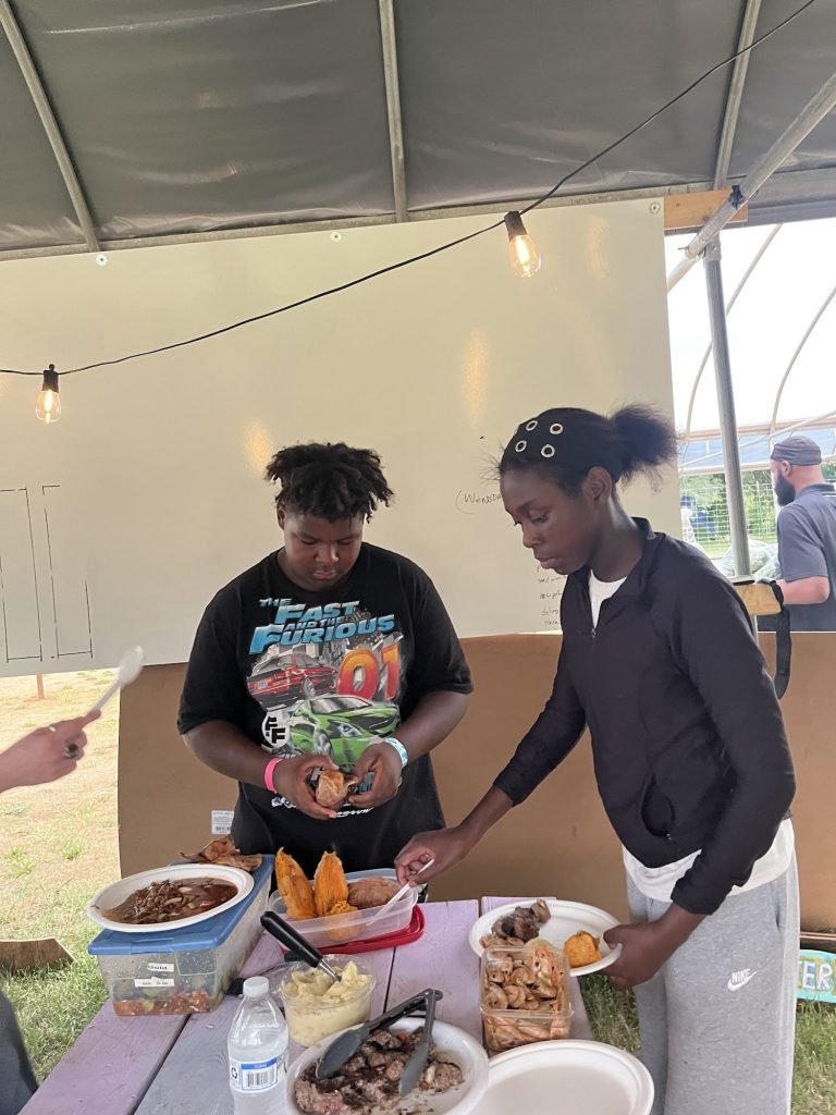 Damari and a Growing Leader preparing a meal at the farm