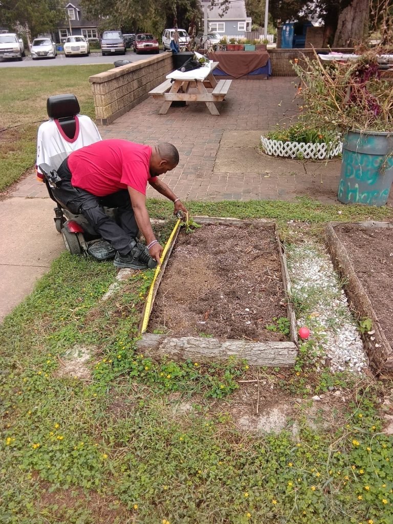 Randy measuring the Healing Garden beds for replacement