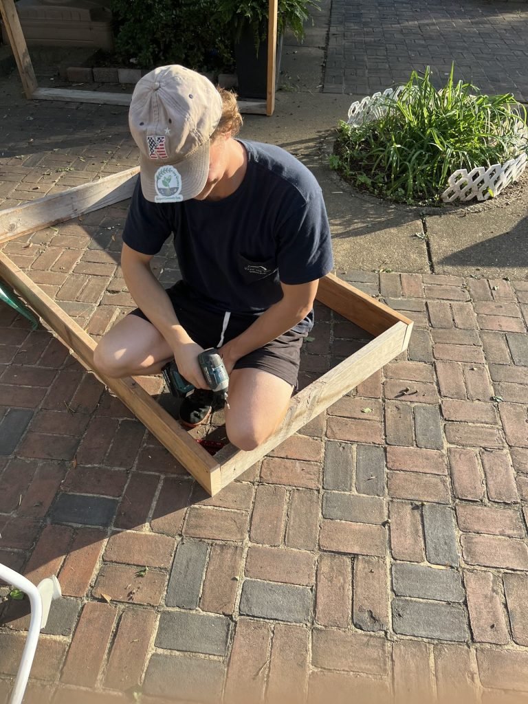 Matthew building new garden boxes for the Healing Garden