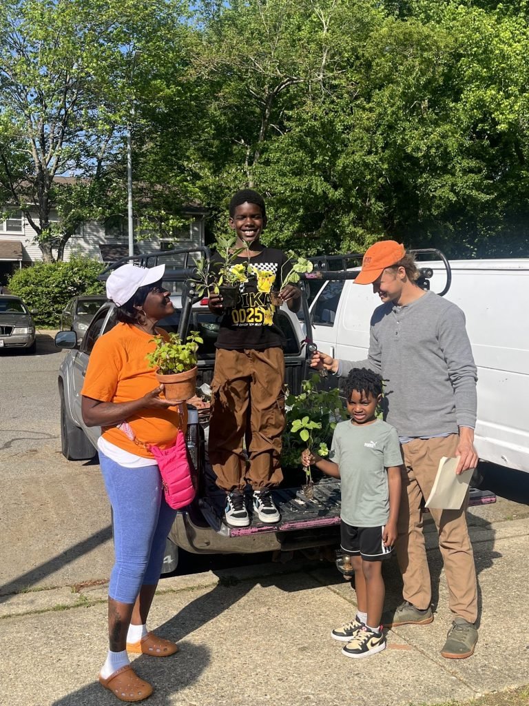Matthew and Donna with kids, delivering spring plants to Robinwood's Great Garden
